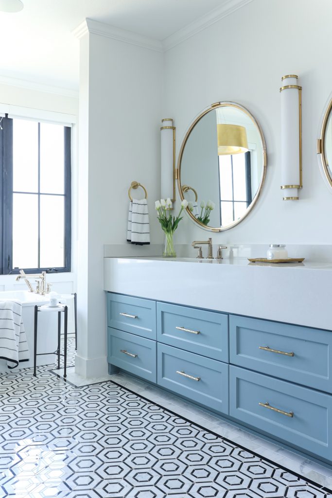 Luxury interior design by Kirkendall Design in Tulsa, OK featuring a spa-like primary bathroom with a large soaking tub, walk-in shower, and double vanities.