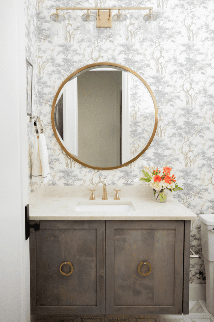 powder bath with floral wallpaper, floating vanity and round mirror, interior design by Kirkendall Design in Tulsa, OK