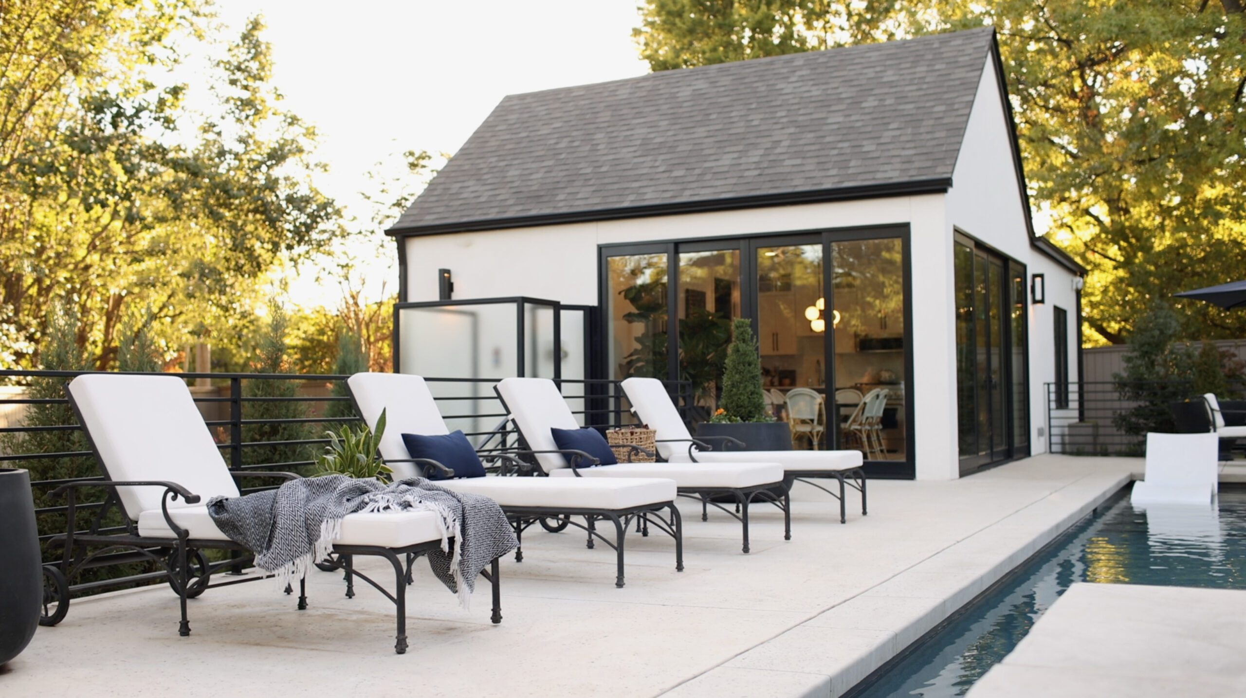 Outdoor living featuring pool and lounge chairs by Kirkendall Design