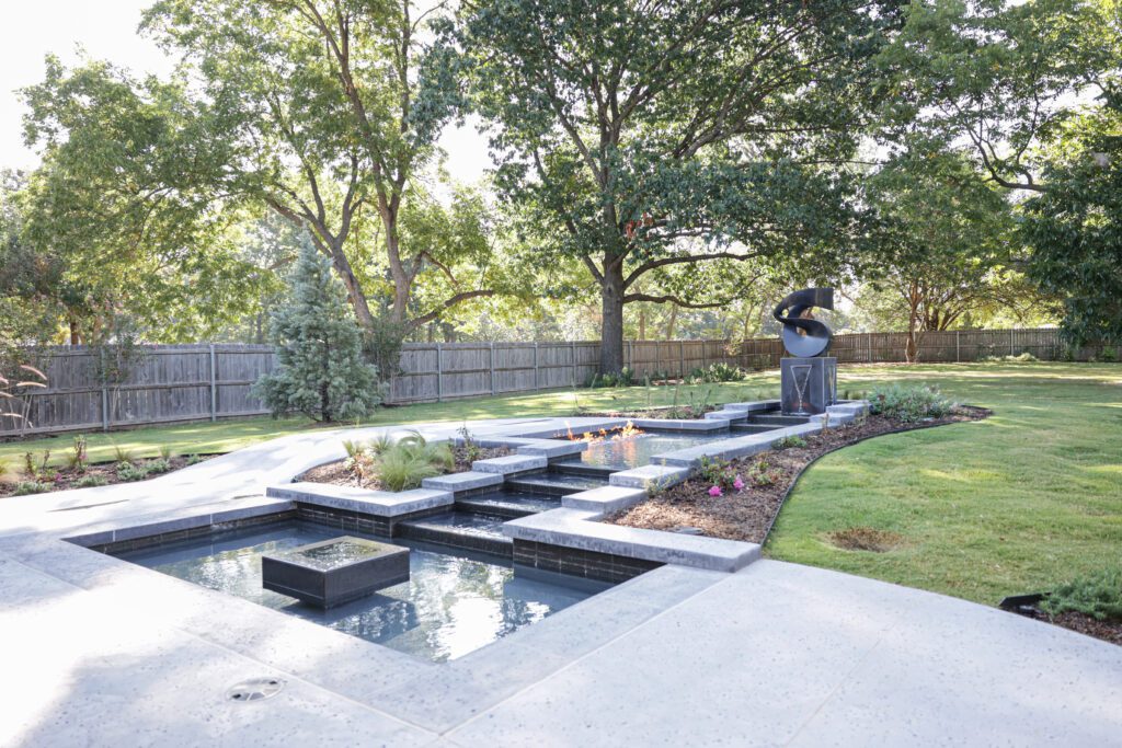 Outdoor living with fountain and statue. Designed by Kirkendall Design