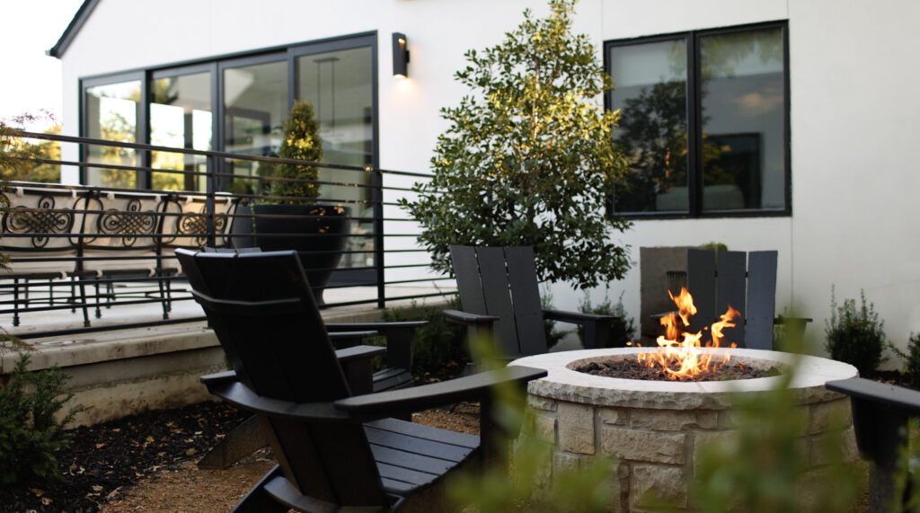 Outdoor living with fire pit and relaxing chairs designed by Kirkendall Design