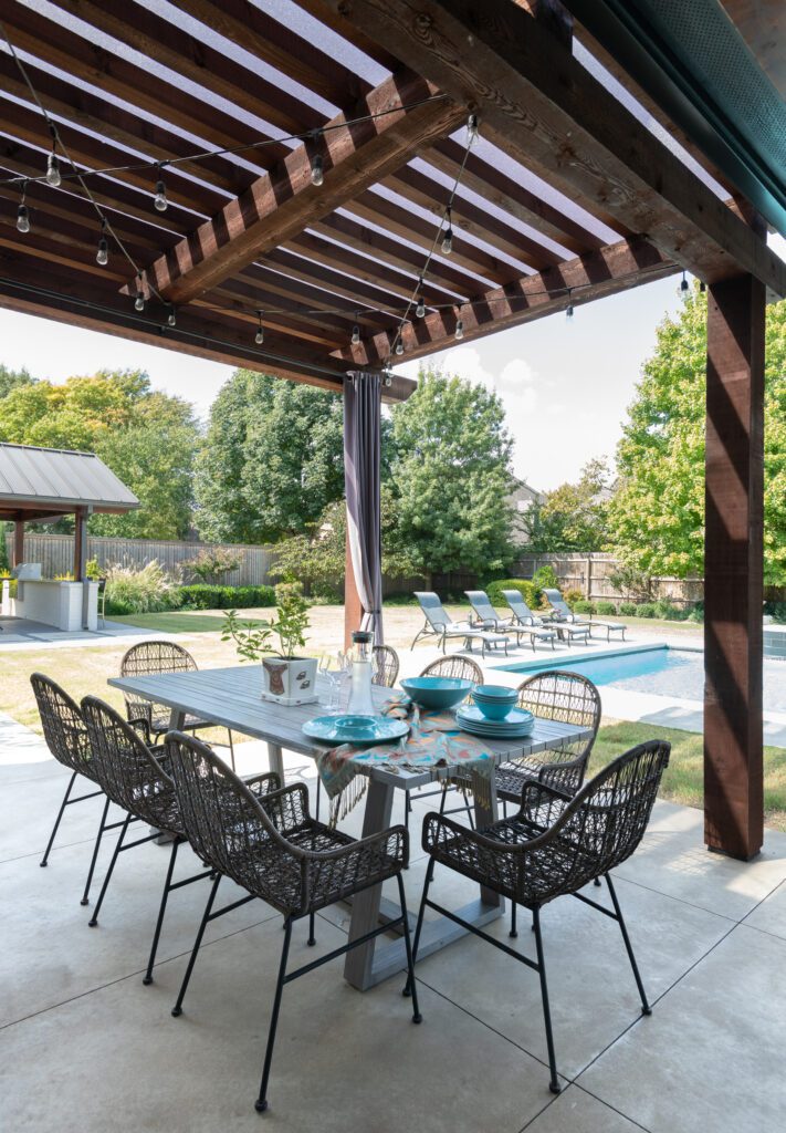 Outdoor living featuring pergola and outdoor dining set, designed by Kirkendall Design