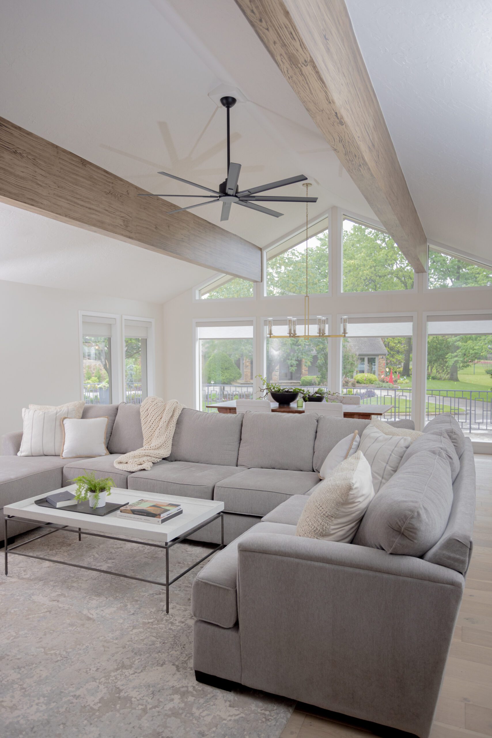 family room with vaulted ceilings and wood beams interior design by Kirkendall Design in Tulsa