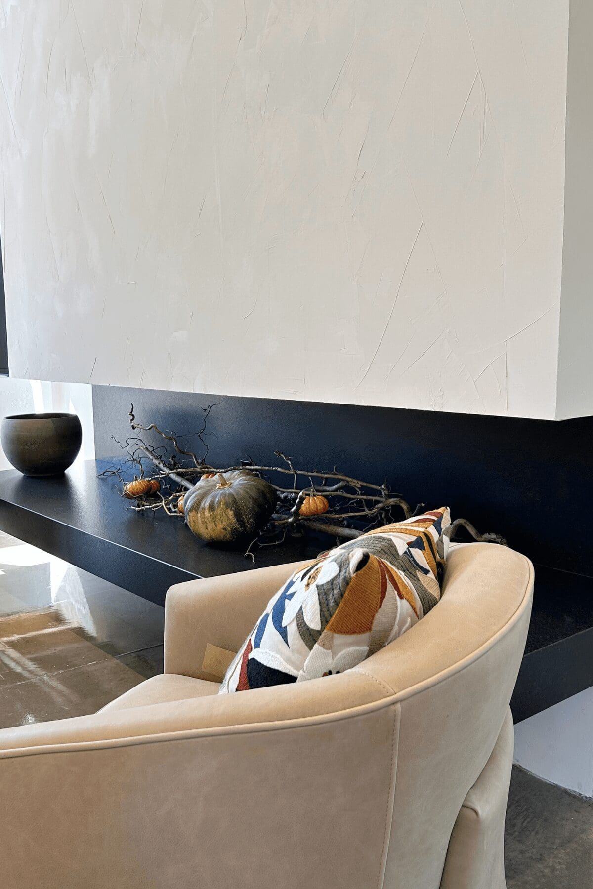 pumpkins and branches styled in large fireplace at commercial office, interior design by Kirkendall Design