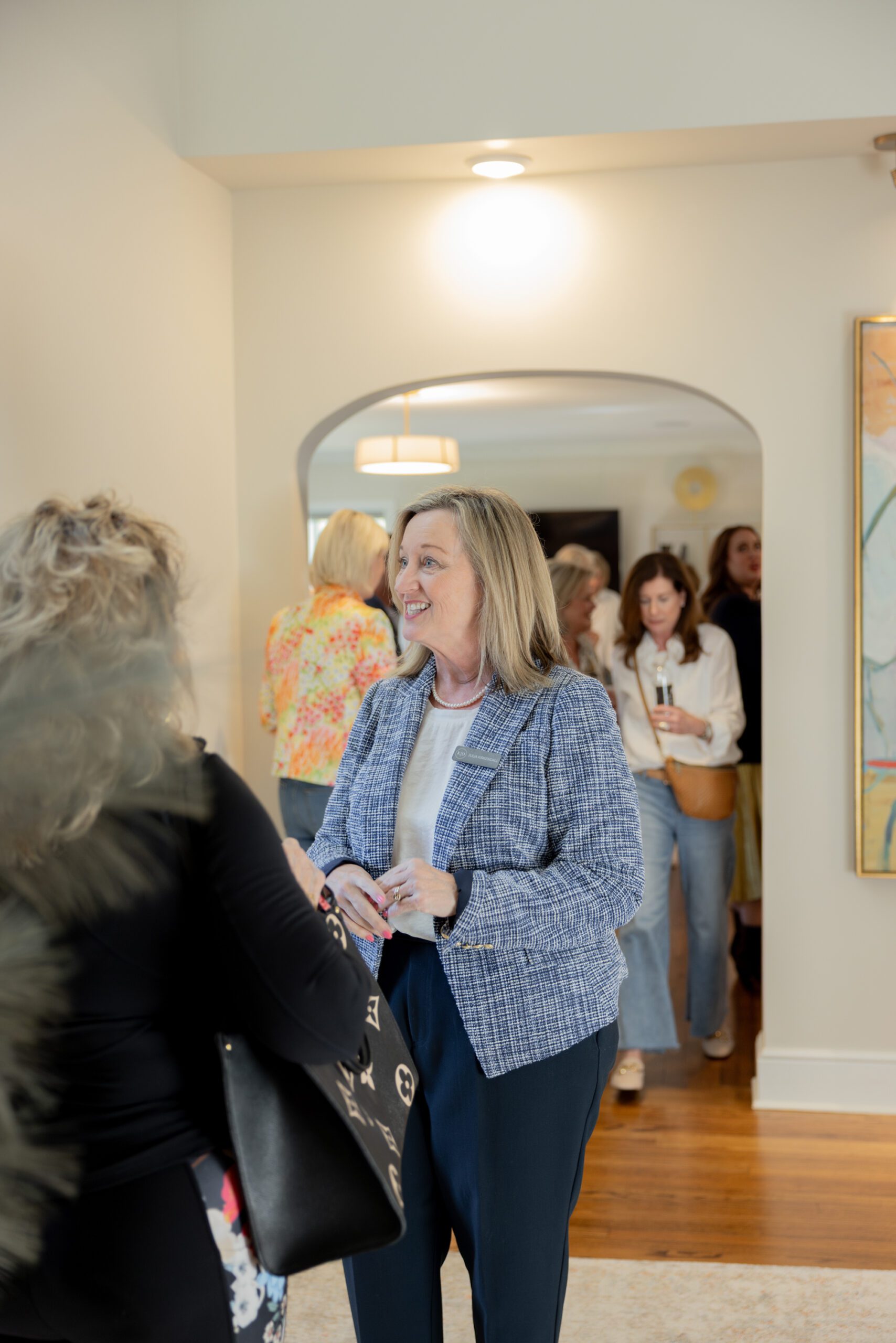 Julia Kirkendall speaking with guests at Designer Spotlight event hosted by Kirkendall Design, interior design firm, in Tulsa OK