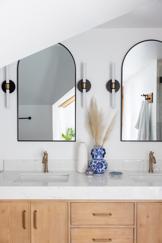 bathroom vanity with oval mirrors interior design by Kirkendall Design in Tulsa, OK