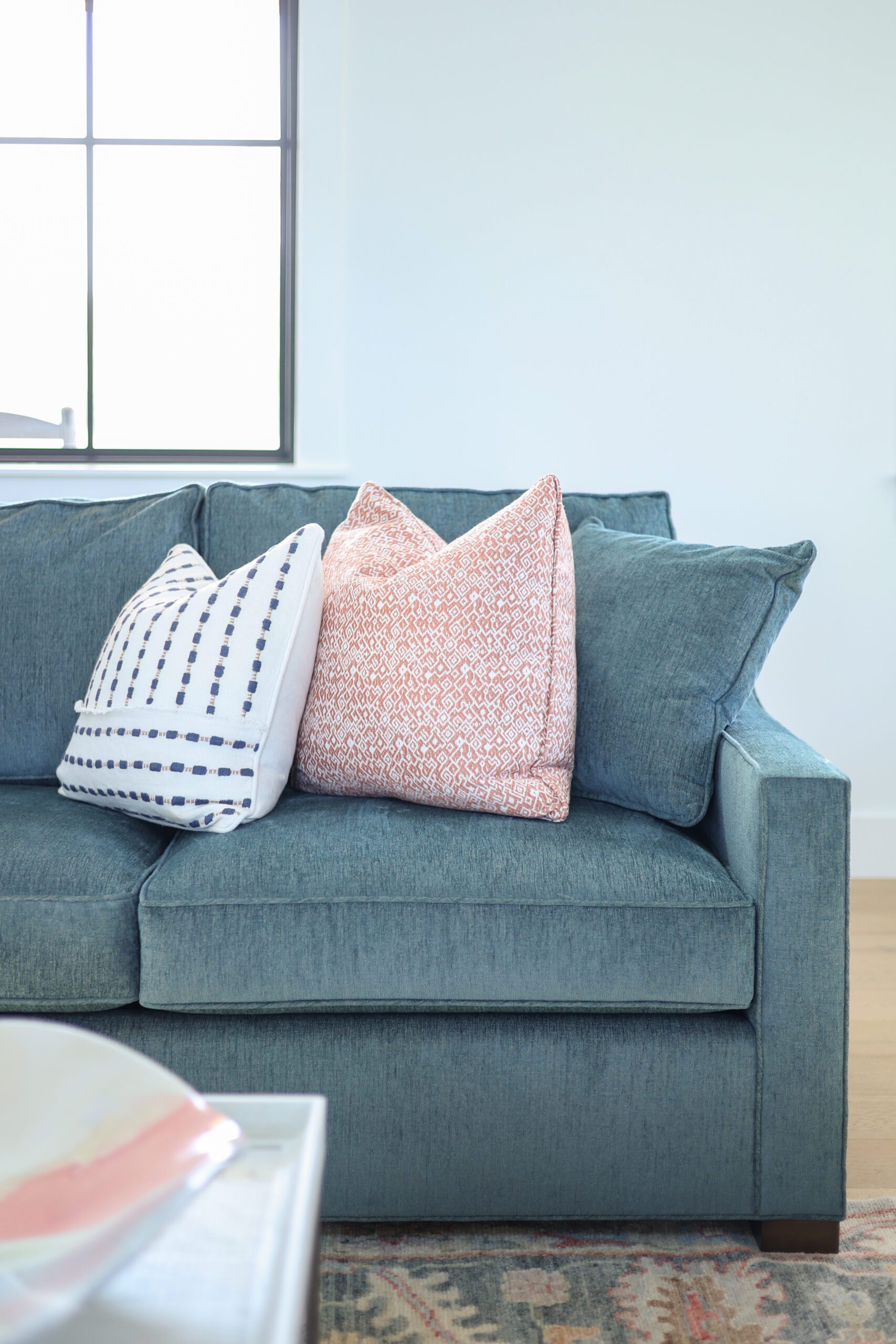 Blue couch with mix of patterned pillows