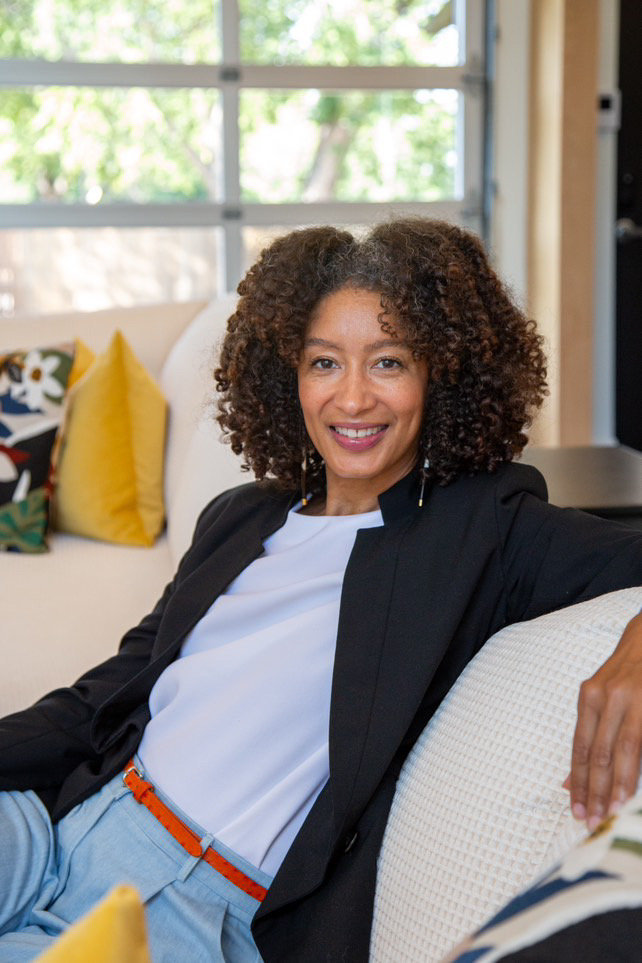 Photography client posing on couch at The Studio at K|D for new professional headshots