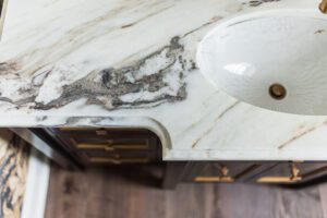 NKBA 2025 award-winning powder bath featuring a curved marble countertop.