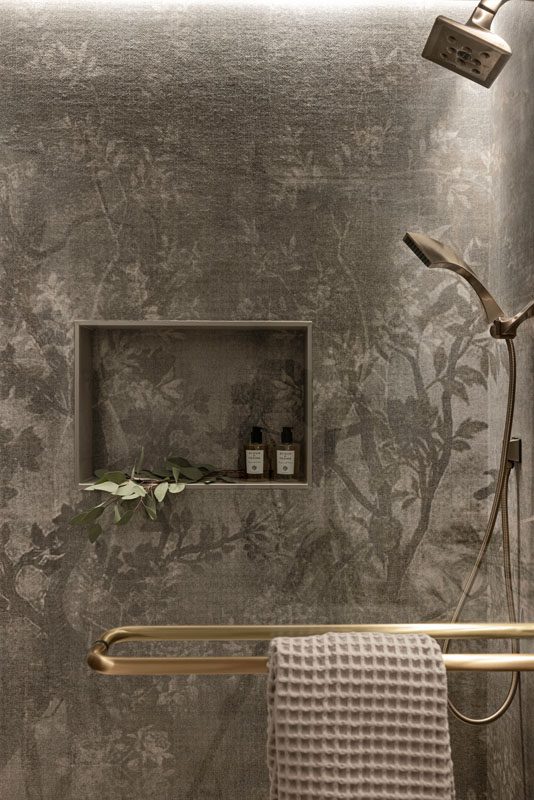 NKBA 2025 award-winning bathroom featuring a botanical tree mural tile in the shower.