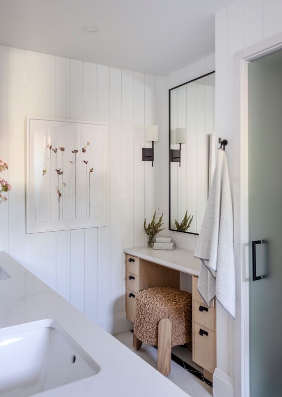 NKBA 2025 award-winning bathroom featuring a black and white motif with shiplap walls and striped tile.