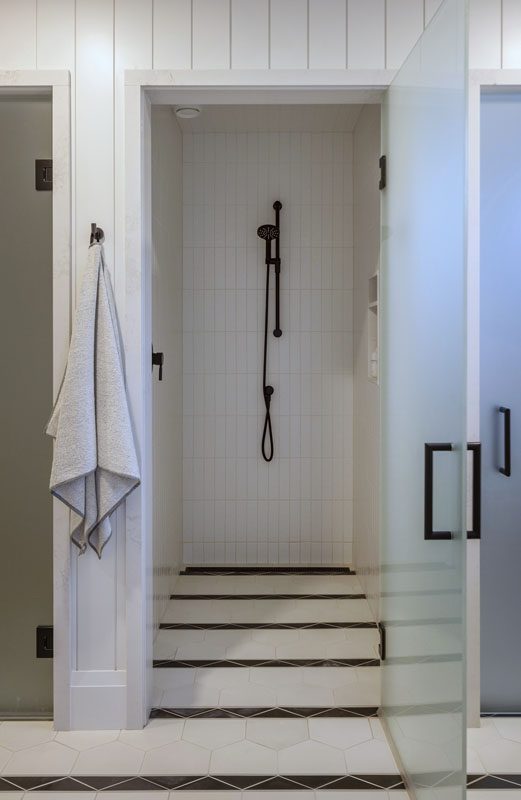 NKBA 2025 award-winning bathroom featuring shiplap walls and striped tile pattern.