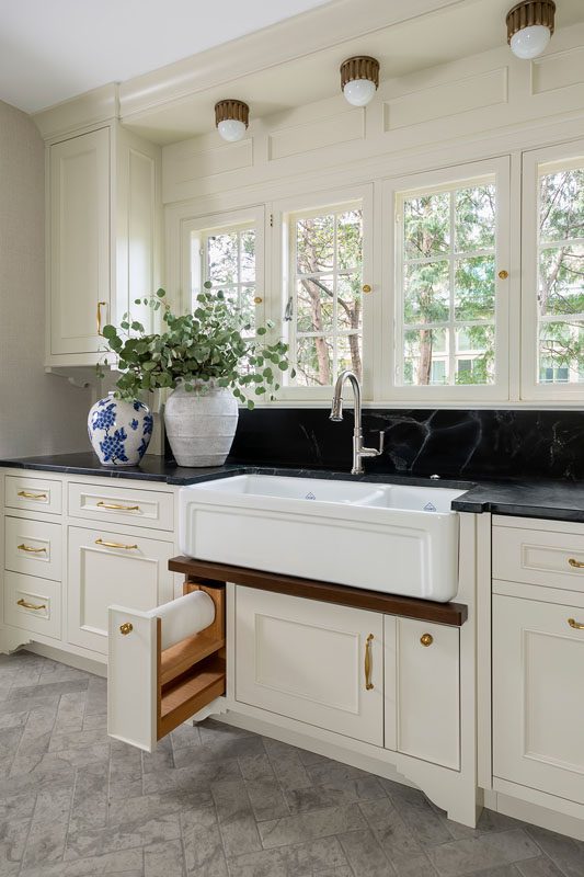 Kitchen with Rohl Shaws farmhouse sink and custom pull-out paper towel holder