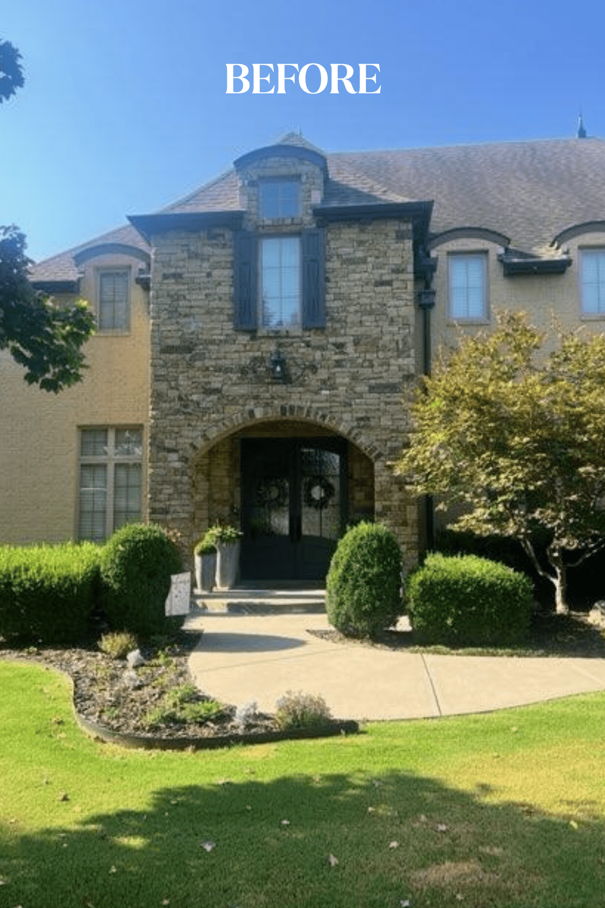 Front view of Tulsa home exterior before limewash treatment showing uneven stone colors