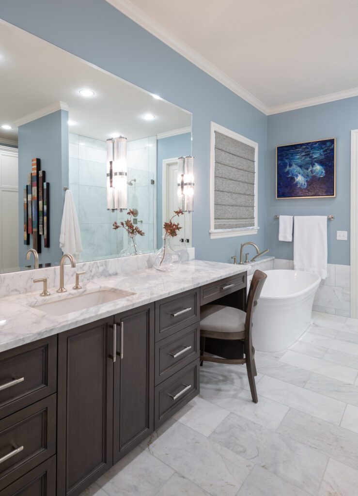 Luxury primary bathroom renovation designed by Kirkendall Design featuring marble flooring, a freestanding soaking tub, walk-in shower, and timeless spa-inspired finishes in this Tulsa multigenerational home.
