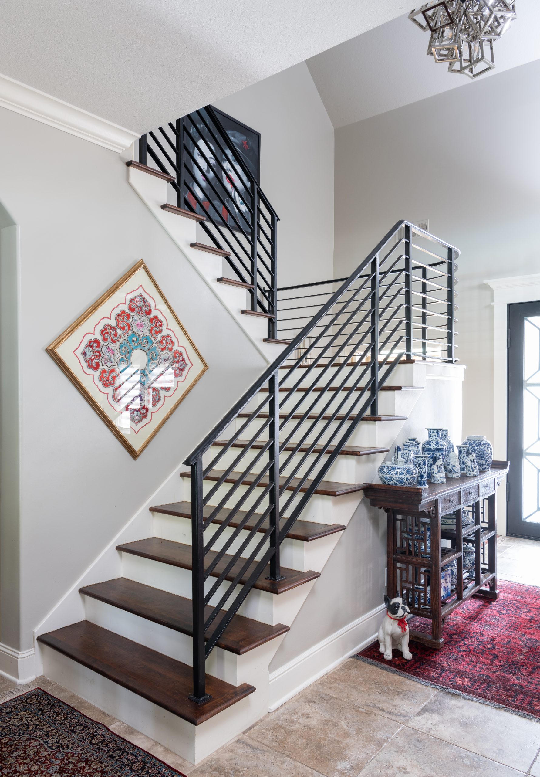 Custom stairwell renovation designed by Kirkendall Design with updated architectural details for this multigenerational luxury Tulsa home.