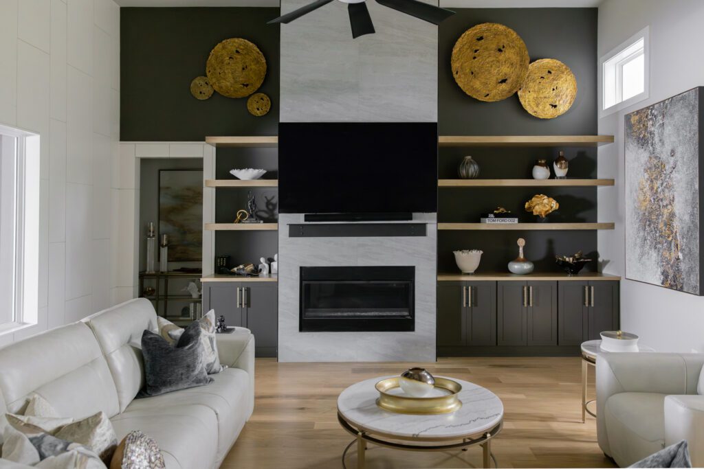 Tulsa interior design living room featuring custom built-ins, fireplace, dark accent wall, and warm wood-look shelving creating a timeless new build home design