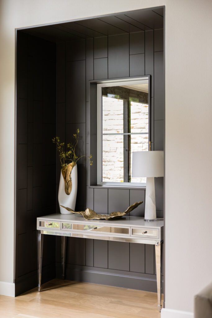 Tulsa interior design entryway featuring a custom alcove painted rich chocolate brown to add depth and architectural detail in a new build home