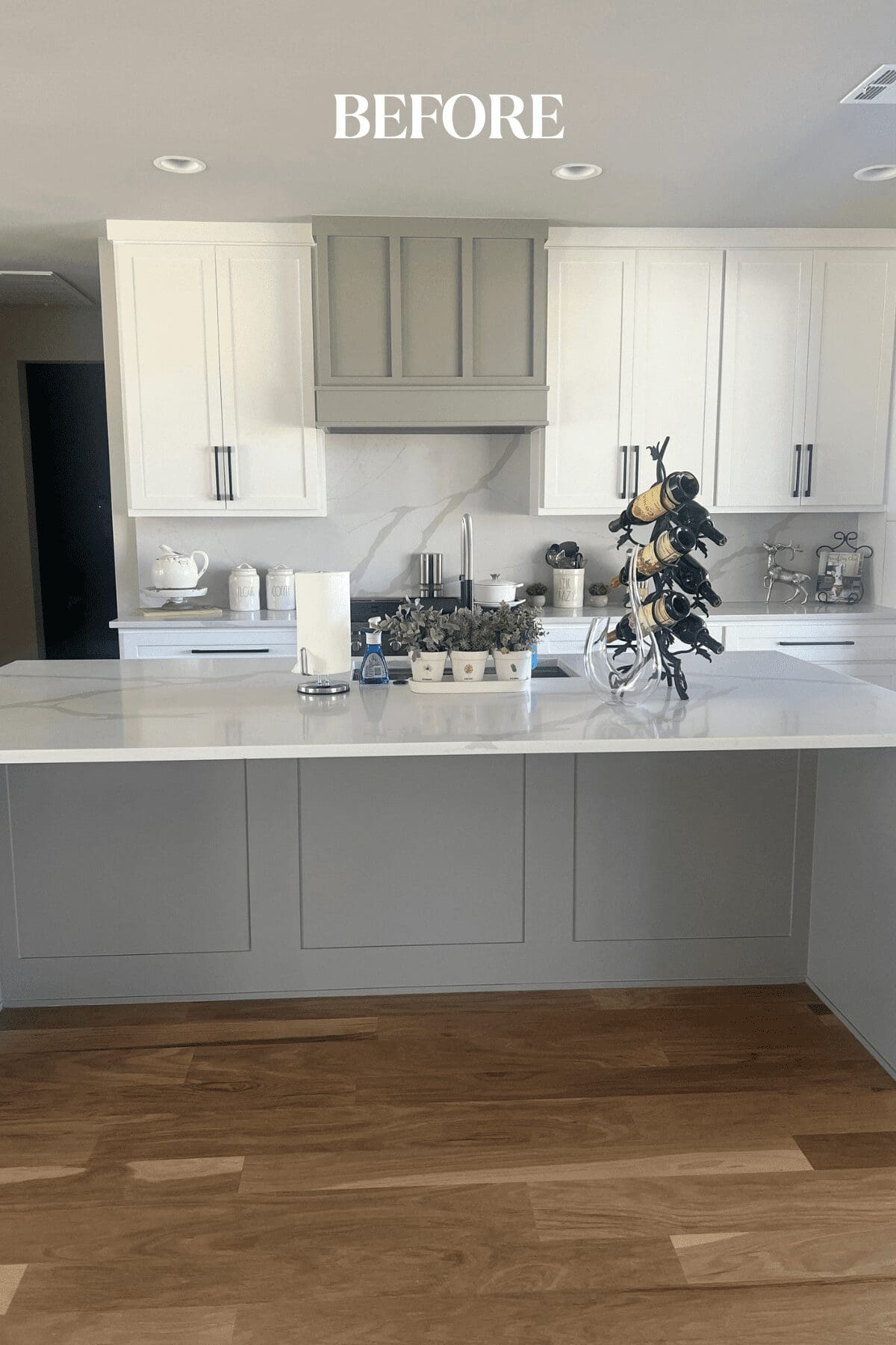 Before photo of a Tulsa new construction home kitchen featuring an all-white and gray palette, builder-selected finishes, and a space ready for personalized interior design updates by Kirkendall Design