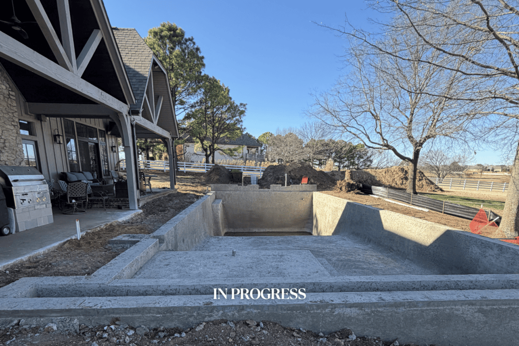 Construction progress of a Kirkendall Design outdoor living project in Tulsa, Oklahoma showing the poured concrete pool installation and backyard