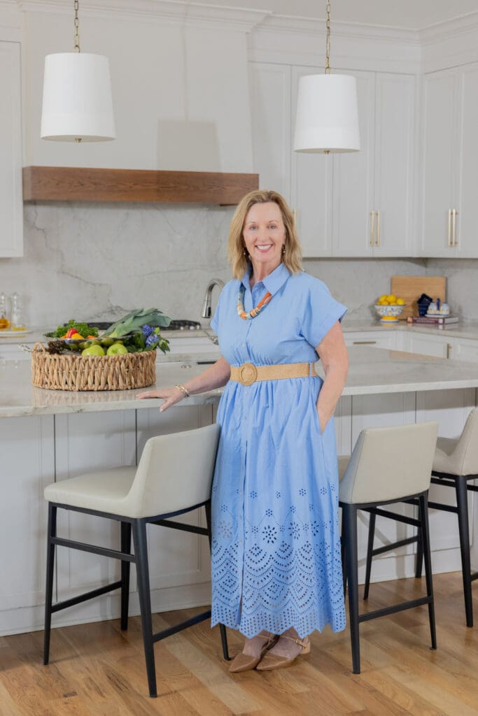 Julia Kirkendall standing in luxury kitchen renovation by Kirkendall Design in Tulsa, OK